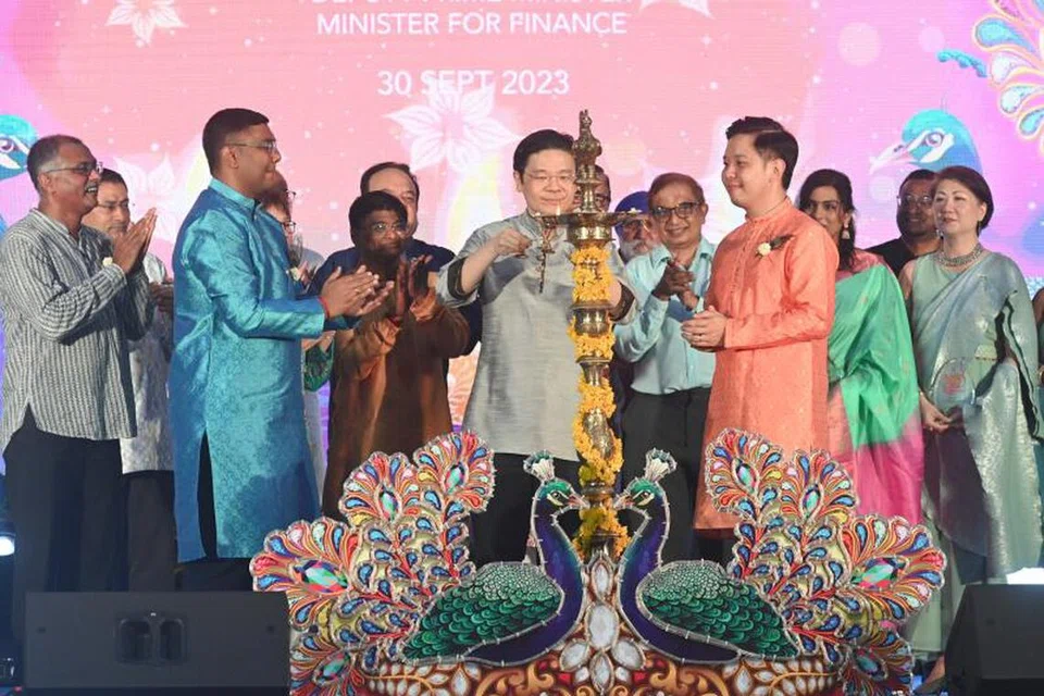 Encik Lawrence Wong (tengah) menyalakan lampu minyak semasa acara penyalaan lampu Deepavali di Little India pada 2023.