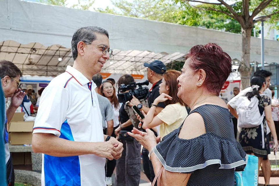 Menteri Negara (Ehwal Dalam Negeri merangkap Pembangunan Negara), Profesor Madya Dr Muhammad Faishal Ibrahim (kiri) berkongsi ciri-ciri Pelan Induk Lima Tahun Bandar Marine Parade bersama penduduk pada 19 April.