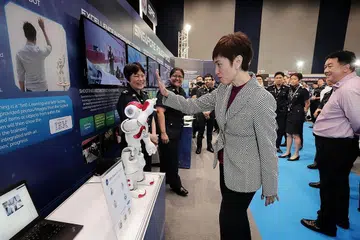 TINJAU TEKNOLOGI BARU: Cik Teo meninjau robot yang menggunakan teknologi PowerAI Vision di pameran Pasukan Polis Singapura (SPF) semasa menghadiri Seminar Pelan Kerja Home Team. - Foto BH oleh KELVIN CHNG