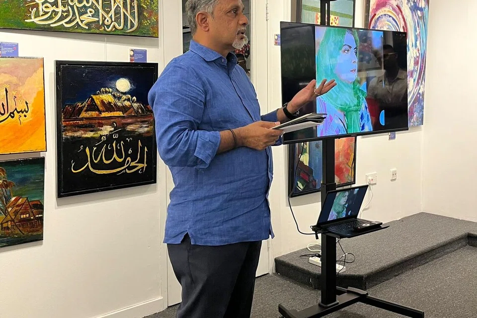 Anak kedua Allahyarhamha Hawa Ammah S.A. Majeed, Encik Firoz Khader, memberikan ucapan semasa pembukaan galeri Celebrating Hawa in Colour pada 21 November di High Street Centre, di 1 North Bridge Road.