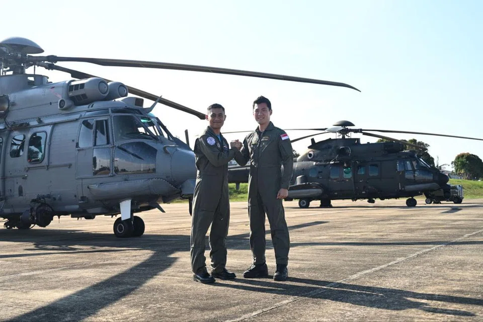 Leftenan Kolonel (LTC) Lim Seng Wee (kanan), Pegawai Pemerintah Angkatan Udara Republik Singapura (RSAF), Skuadron 125 bersama Lt. Kol. Ahmad Farhan Ahmad (kiri), Pegawai Pemerintah, Tentera Udara Diraja Malaysia (RMAF), Skuadron 10 berada di hadapan helikopter RSAF H225M (belakang) and RMAF EC725 (depan) yang menyertai Latihan Search-And-Rescue (SAREX) MALSING 2024.