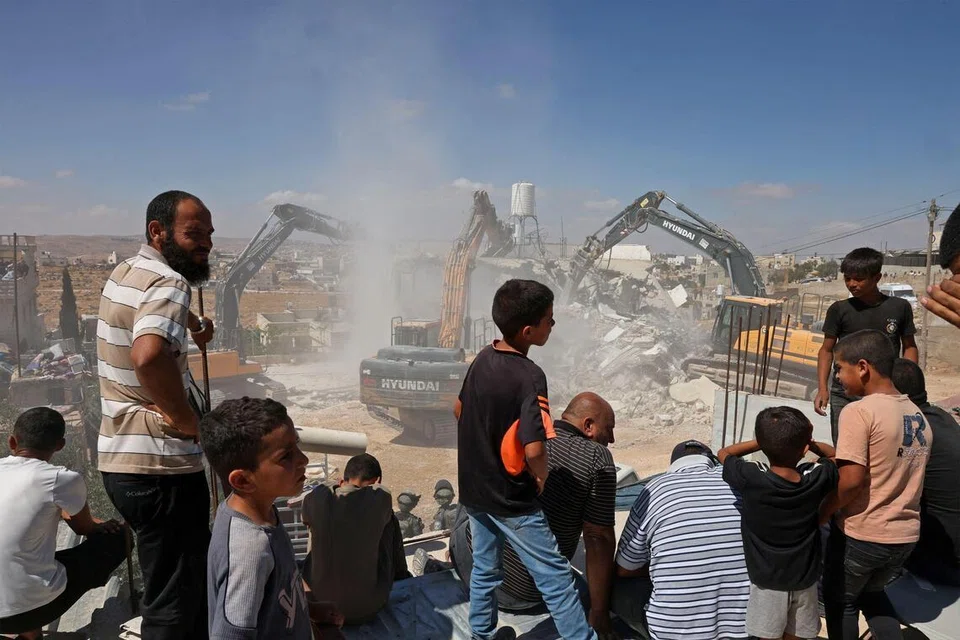 Penduduk menyaksikan jengkaut Israel merobohkan sebuah rumah milik penduduk Palestin yang didakwa dibina tanpa permit di kampung Al-Rifayia, selatan Hebron, di Tebing Barat yang diduduki, pada 9 Julai 2026.