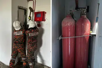 TERPERANGKAP: Anggota bomba kelihatan memecah masuk sebuah bilik penyimpanan tong karbon dioksida selepas menerima panggilan dua orang terperangkap di dalamnya pada 17 Januari.