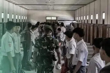 Para pelajar berdiri dalam barisan pada 5 Mei 2025 di sebuah berek tentera sambil menjalani latihan intensif pembentukan watak dan disiplin di pusat pendidikan ketenteraan yang terletak di Kabupaten Bandung Barat, Jawa Barat. Ratusan pelajar dari pelbagai wilayah di seluruh Jawa Barat yang terlibat dalam pergaduhan jalanan, geng motosikal, atau ketagihan permainan dalam talian sedang menjalani latihan intensif yang dikendalikan oleh anggota Tentera Nasional Indonesia (TNI) selama sekurang-kurangnya 14 hari.