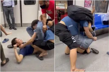 Tangkap layar dari video yang dikongsi menerusi media sosial menunjukkan seorang lelaki berbaju biru gelap di lantai kereta api MRT, menumbuk dan menendang seorang lelaki lain.