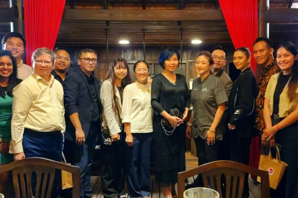 Encik Hanizam Mohamed Yasin (enam dari kiri) bersama Cef Kemboja, Cik Ros Rotanak (sembilan dari kanan), dan Cef Singapura, Cik Petrina Loh (tujuh dari kanan), bersama seluruh pasukan kulinari dalam sebuah majlis makan malam eksklusif sempena sambutan 60 tahun hubungan diplomatik antara Kemboja dengan Singapura.