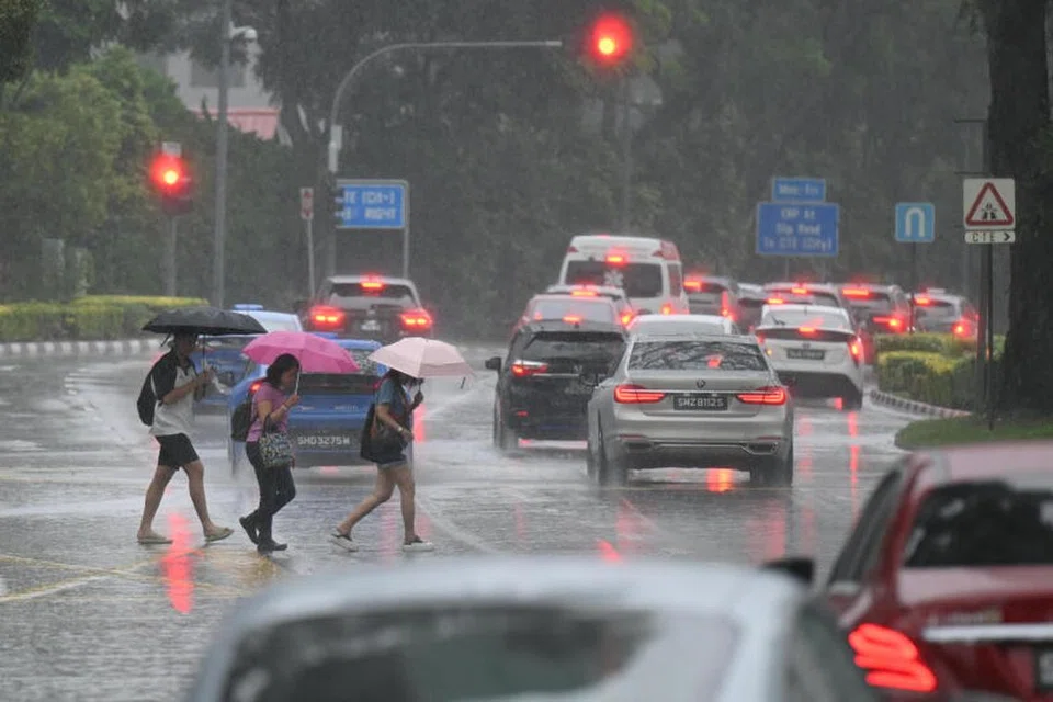 Orang ramai membawa payung sambil mengharungi hujan di di Moulmein Road pada 22 November 2024.