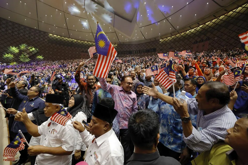 RAIKAN BERSAMA RAKYAT: Perdana Menteri Malaysia, Datuk Seri Anwar Ibrahim (tengah), mengibarkan bendera Malaysia Jalur Gemilang bersama hadirin semasa hadir pada Majlis Amanat Perdana Hari Kebangsaan 2023 di Pusat Konvensyen Antarabangsa Putrajaya (PICC) pada Rabu.