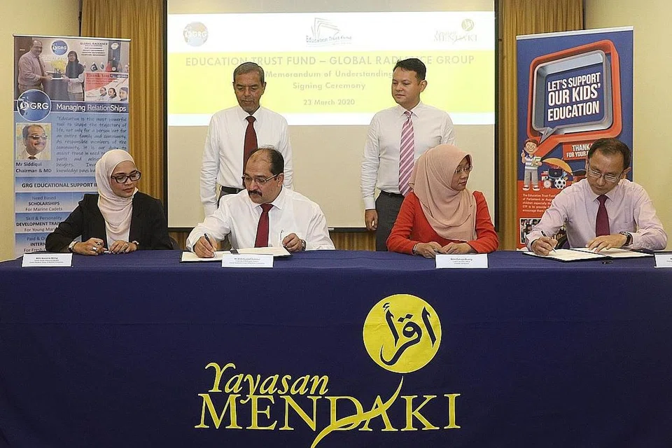 DERMASISWA DIPERKENAL: (Dari kanan, berdiri) Menteri Negara (Pembangunan Negara merangkap Tenaga Manusia), Encik Zaqy Mohamad, dan Pengerusi ETF, Encik Haji Abdul Razak Maricar, memerhati penandatanganan yang dilakukan (dari kiri, duduk) Pengurus Sumber Manusia Kanan GRG, Cik Nooraine Minhaj; Pengerusi dan Pengarah Pengurusan GRG, Encik Abdul Lateef Siddiqui; Ketua Pegawai Eksekutif Yayasan Mendaki, Cik Rahayu Buang; dan Timbalan Pengarah Kerjasama Korporat, Encik Noor Azlan Salim; di Wisma Mendaki semalam. - Foto BH oleh MARCELLIN LOPEZ