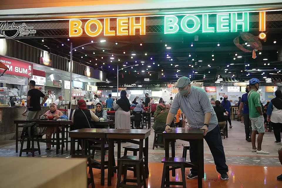 BUAT PERSIAPAN: Pusat makanan Boleh Boleh! telah membuat persiapan seperti melatih kakitangannya, bekerjasama dengan duta jarak selamat serta meletakkan tanda jarak selamat bagi memastikan pelanggan mematuhi langkah pengurusan selamat - Foto BH oleh GIN TAY