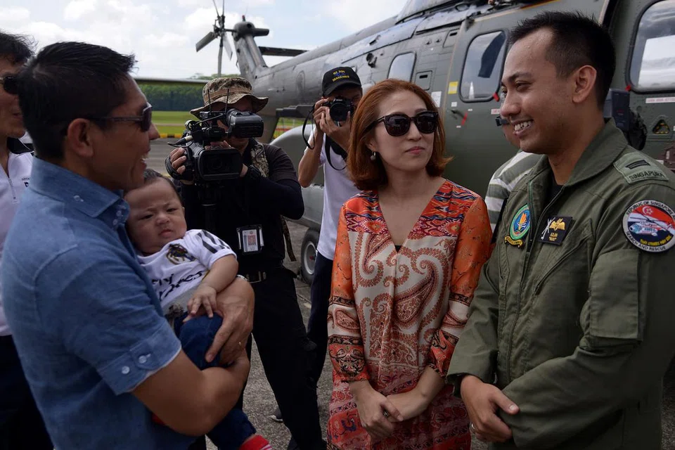 BERINTERAKSI DENGAN PEGAWAI RSAF: Dr Maliki (kiri) berbual dengan juruterbang helikopter Super Puma, Kapten Azlan, yang membawa isterinya, Cik Nur Alisha Kim, dan anak mereka, Aaron Azlan, ke acara pratonton rumah terbuka RSAF. - Foto SHAKIR SAIFUDDIN