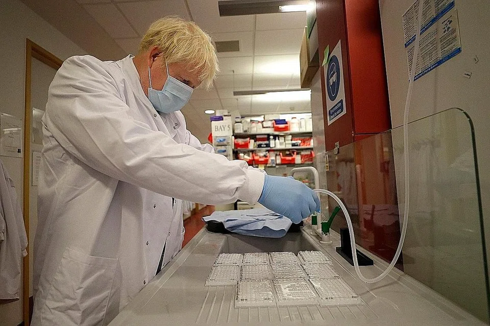 KUNJUNGAN PERDANA MENTERI: Encik Boris Johnson membasuh alat imunologikal semasa lawatan ke Institut Jenner di Oxford, tengah England, di mana beliau melawat makmal dan bertemu dengan saintis yang mengetuai penyelidikan vaksin Covid-19. - Foto: AFP