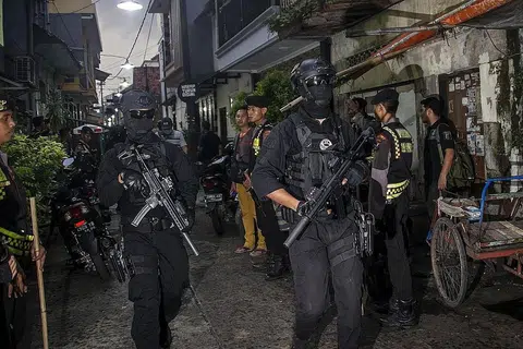 JAGA KEAMANAN: Polis antipengganasan Indonesia melakukan serbuan di Surabaya pada 9 Disember lalu. Lebih 12 orang ditangkap tersebut sebagai usaha antipengganasan demi menjaga keamanan menjelang cuti Krismas dan Tahun Baru. - Foto AFP