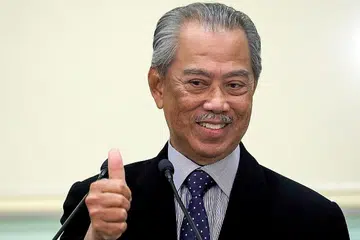 DISENANGI RAKYAT: Tujuh daripada 10 rakyat Malaysia berpuas hati terhadap prestasi Tan Sri Muhyiddin sebagai perdana menteri. - Foto REUTERS
