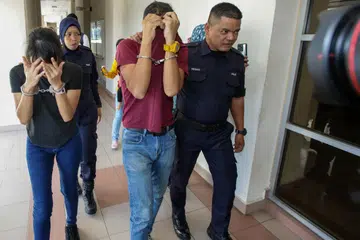 Pasangan suami Isteri, Sofian Mustafa Zin (tengah) dan Nabila Huda Fadli,  (kiri) didakwa atas kesalahan penganiayaan terhadap bayi lelaki berumur 16 bulan dengan memberi air susu bercampur dengan air mengandungi dadah.