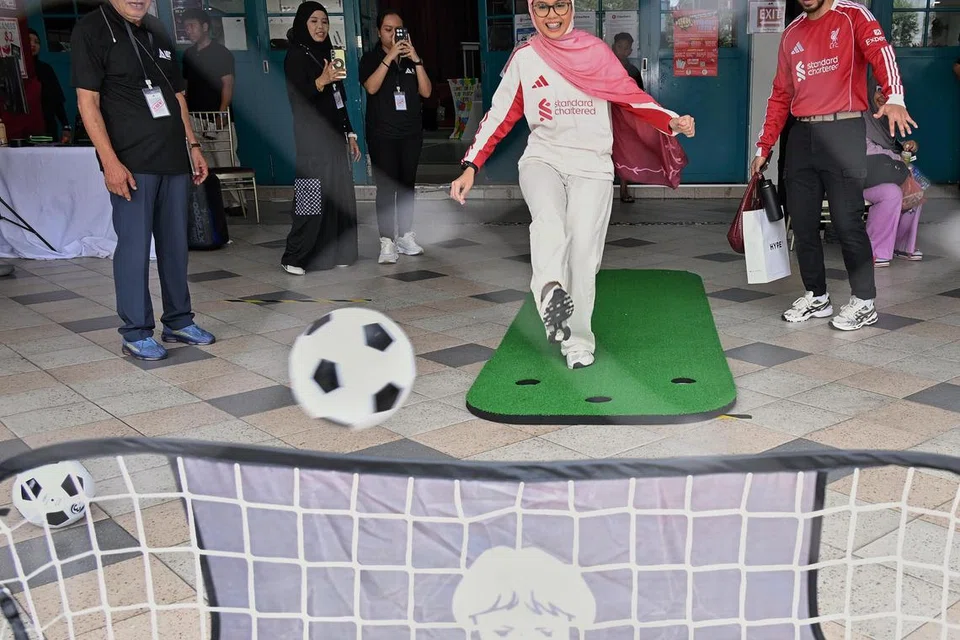 Pengunjung di Fund the Fight Fiesta SG60’ dapat menikmati permainan bola sepak.