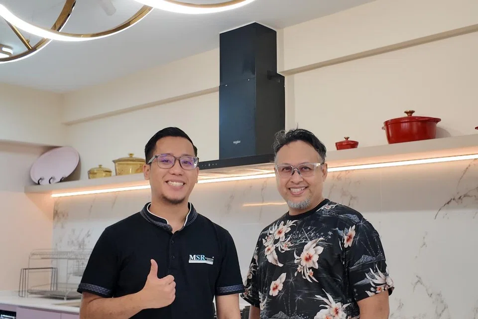 Encik Nauruz (kanan) bersama Encik Sharyzan Shamsudin daripada MSR Interior Design, bergambar di dapur konsep terbuka di kediamannya di Tampines. 