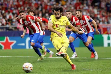 TIGA MATA PENTING: Salah menjaringkan gol kemenangan Liverpool menerusi tendangan penalti ketika menewaskan Atletico Madrid 3-2 kelmarin. - Foto EPA-EFE