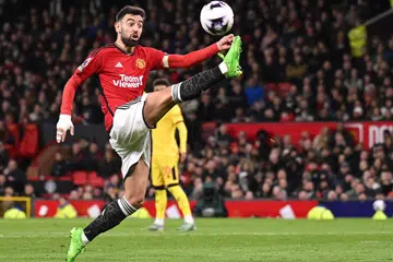 Pemain tengah Manchester United, Bruno Fernandes, mengawal bola semasa perlawanan EPL menentang Sheffield United di Old Trafford  pada 24 April.