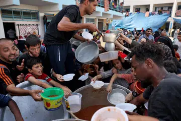 Kanak-kanak Palestin berebut-rebut mendapatkan bantuan makanan di sebuah sekolah kelolaan Pertubuhan Bangsa-Bangsa Bersatu (PBB) di Rafah, di tengah-tengah berkurangnya kemasukan bantuan kemanusiaan ke Gaza.