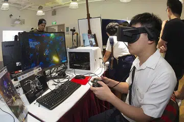 TEKNOLOGI BARU: Seorang pelajar sedang mencuba alat realiti tambahan di Sekolah Teknologi Infokom Politeknik Ngee Ann. Demi mempertingkat kemahiran pegawai awam, pemerintah akan menubuhkan Pusat Kecemerlangan bagi Teknologi Infokom. - Foto fail