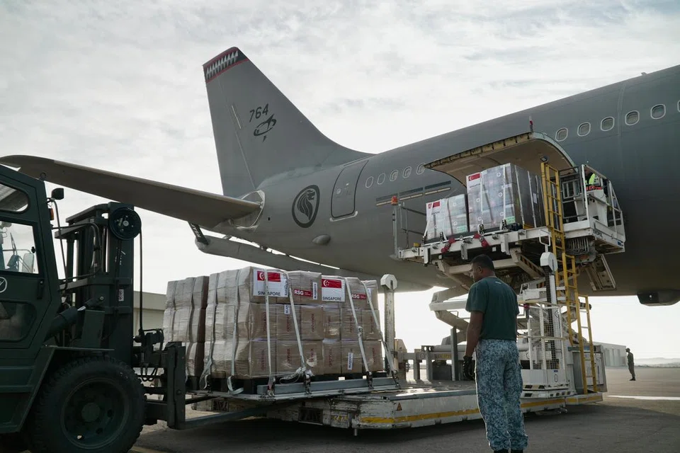 SELAMAT TIBA: Kakitangan Angkatan Udara Republik Singapura (RSAF) memungah barangan bantuan daripada pesawat A330 Pengangkutan Tangki Pelbagai Peranan (MRTT) RSAF.