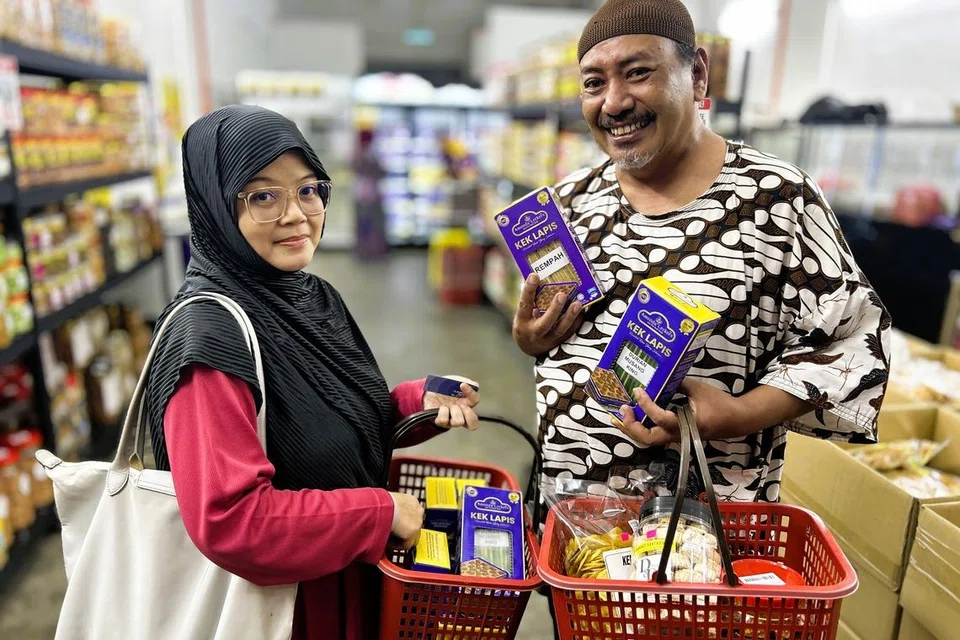 Encik Mohamad Latif Mon (kanan), bersama isterinya Cik Rasidah Bahrom, gembira dapat menemukan kuih Raya dan kek lapis di satu lokasi.