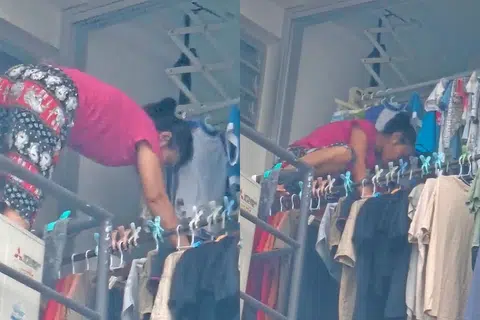 Seorang pembantu rumah dilihat panjat keluar tingkap di dapur menyidai jemuran, tanpa peralatan keselamatan di tingkat 18. Lokasi flat tidak didedahkan. 