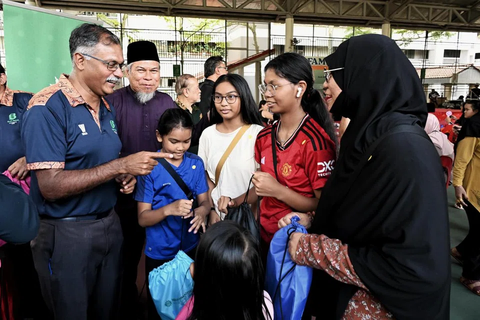 Menteri Negara (Undang-Undang merangkap Pengangkutan), Encik Murali Pillai (kiri) bersama Pengerusi Eksekutif Kanan Masjid Ar-Raudhah, Ustaz Mohamed Ali Atan (dua dari kiri) dan penerima bantuan, Cik Faridah Abdullah (kanan) bersama tiga anaknya. 