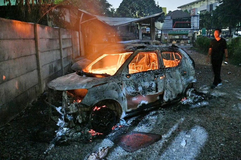 MARAK DENGAN API KEMARAHAN: Penunjuk perasaan membakar kereta di kompleks perumahan Briged Polis Bergerak (Brimob) di Jakarta Barat, Indonesia, kelmarin. - Foto REUTERS