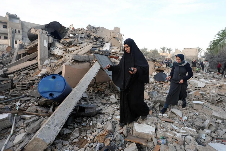 Penduduk Palestin memeriksa tapak serangan udara Israel ke atas sebuah rumah, di tengah-tengah konflik yang berterusan antara Israel dan Hamas, di Deir Al-Balah, Gaza Tengah, pada 15 Januari 2025. 