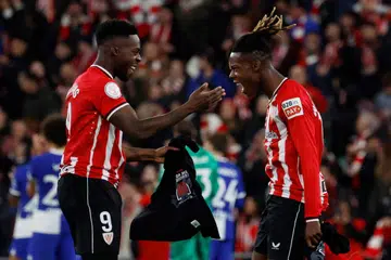 Pasangan adik-beradik dari Athletic Bilbao, Inaki Williams (kiri) dan Nico Williams meraikan kemenangan sejurus selepas tamat perlawanan dengan Atletico Madrid di San Mames, Bilbao, Sepanyol pada 29 Februari.