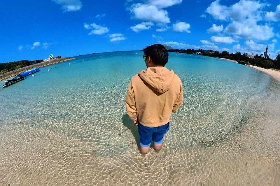 Encik Muhamad Fariqqin Anuar menghayati pemandangan indah pantai Nabee di Okinawa pada Mac 2023.