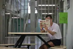 Andy (bukan nama sebenar), salah seorang peserta Project Rekindle sedang membaca siri komik manga Jepun kegemarannya di Institusi A3 Kompleks Penjara Changi pada 20 Disember 2024.