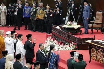 Presiden Joko ‘Jokowi’ Widodo (atas, kanan) menghadiri majlis perasmian Anggota Parlimen di bangunan Parlimen di Jakarta, Indonesia, pada 1 Oktober dengan 732 anggota Majlis Perwakilan Rakyat (MPR) mengangkat sumpah untuk berkhidmat dari 2024 hingga 2029.