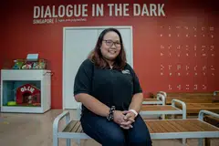 Cik Norliana Mohamed Ajam didiagnosis menghidap penyakit mata yang jarang berlaku, dipanggil uveitis. Beliau menyertai program, ‘Dialogue In The Dark SG’ (DiDsg)  kerana mendapati manusia dapat bersikap lebih jujur apabila terperangkap dalam kegelapan. 