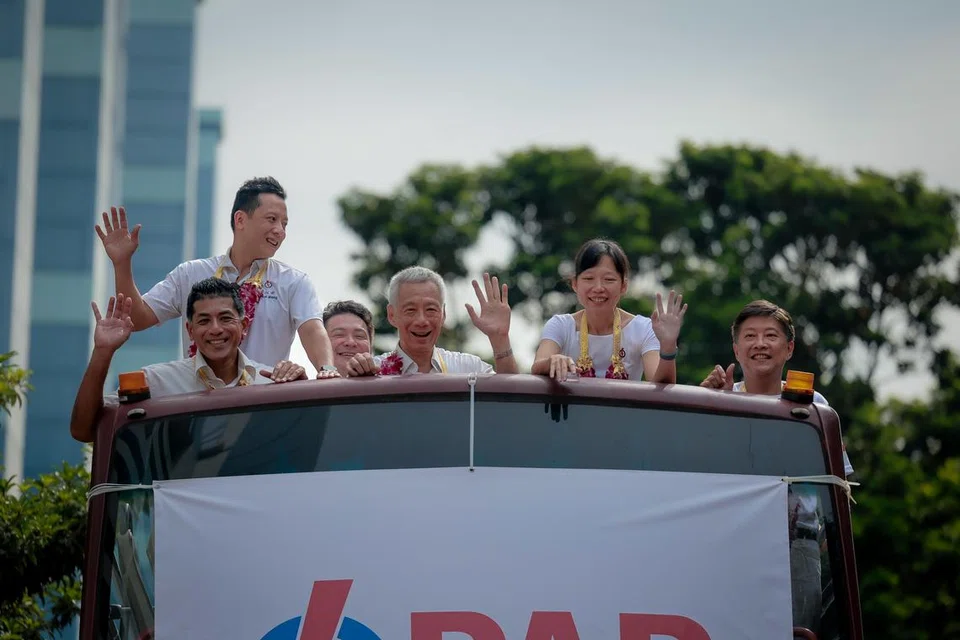 Menteri Kanan, Encik Lee Hsien Loong (tengah) bersama AP GRC Ang Mo Kio menaiki bas untuk meraikan kemenangan mereka di sekitar Ang Mo Kio pada 4 Mei.