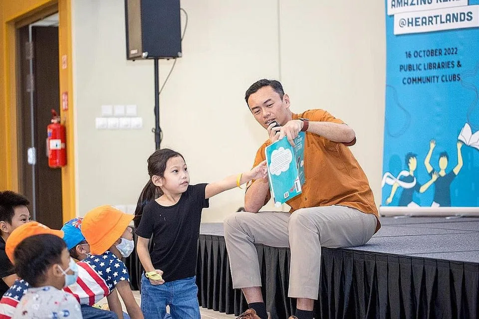SERONOK MEMBACA: Dr Wan Rizal Wan Zakariah membaca buku 'The Crane and the Crab' kepada ibu bapa dan kanak-kanak yang hadir pada acara Amazing Read @ Heartlands di M³@Jalan Besar. - Foto FACEBOOK DR WAN RIZAL WAN ZAKARIAH
