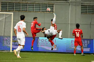 Penyerang Vietnam, Nguyen Xuan Son,melakukan aksi sepakan bicycle kick, dengan kapten dan pemain pertahanan Singapura Safuwan Baharudin (jersi nombor 21) cuba menghalang percubaan Xuan Son. Barisan pertahanan Singapura, bijak mengawal Xuan Son sepanjang perlawanan separuh akhir pertama Piala Mitsubishi Electric 2024 pada 26 Disember di Stadium Jalan Besar. 