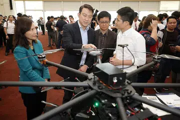 PENGGUNAAN MELUAS: CEO Garuda Robotics Encik Mark Yong (kanan) sedang memberi penerangan tentang teknologi dron yang penggunaannya kian meluas kepada Dr Lam Pink Min (dua dari kiri). Bersama mereka ialah Cik Low Khah Gek (kiri) dan CEO Pusat Sains Singapura, Profesor Madya Lim Tit Meng (dua dari kanan). - Foto BH oleh GAVIN FOO