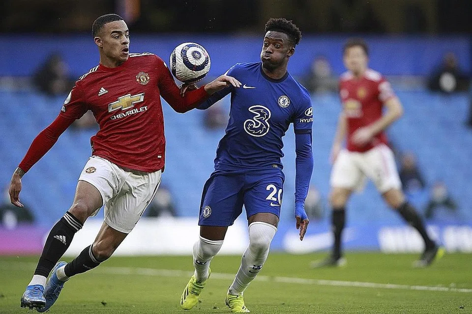 PENALTI ATAU TIDAK? Greenwood (kiri) dan Hudson-Odoi (kanan) bergelut bola dalam perlawanan seri tanpa gol antara Manchester United dengan Chelsea kelmarin di Stamford Bridge. - Foto-foto EPA-EFE 