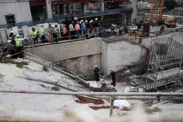 MANGSA KREN RUNTUH: Mayat mangsa kren yang runtuh ditutup dengan kain putih (bawah, kanan) di tapak pembinaan di Jalan Tan Tock Seng semalam. - Foto BH oleh KELVIN CHNG