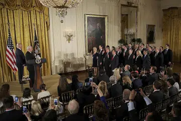 BARISAN BARU: Encik Donald Trump (kiri) memerhatikan upacara angkat sumpah kakitangan kanan di Rumah Putih yang dipimpin oleh Naib Presiden Mike Pence (dua dari kiri) semalam. - Foto REUTERS