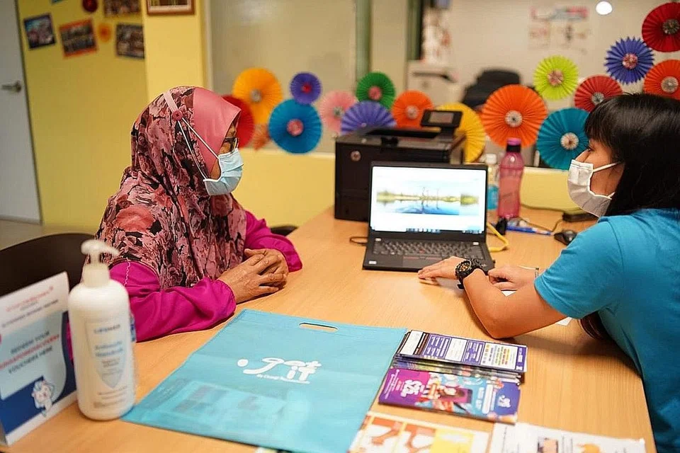 DAPAT BANTUAN: Walaupun kurang celik teknologi, Cik Hasnah Khamis (kiri) gembira dapat bantuan daripada Changi Travel Services bagi menempah kegiatan dalam talian untuk ke tempat tarikan Royal Albatross di Sentosa. - Foto BM oleh NUR DIYANA TAHA