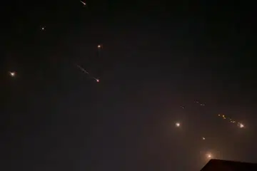 Beberapa letupan menerangi langit di Hebron, Wilayah Palestin, semasa serangan Iran ke atas Israel pada 14 April. 