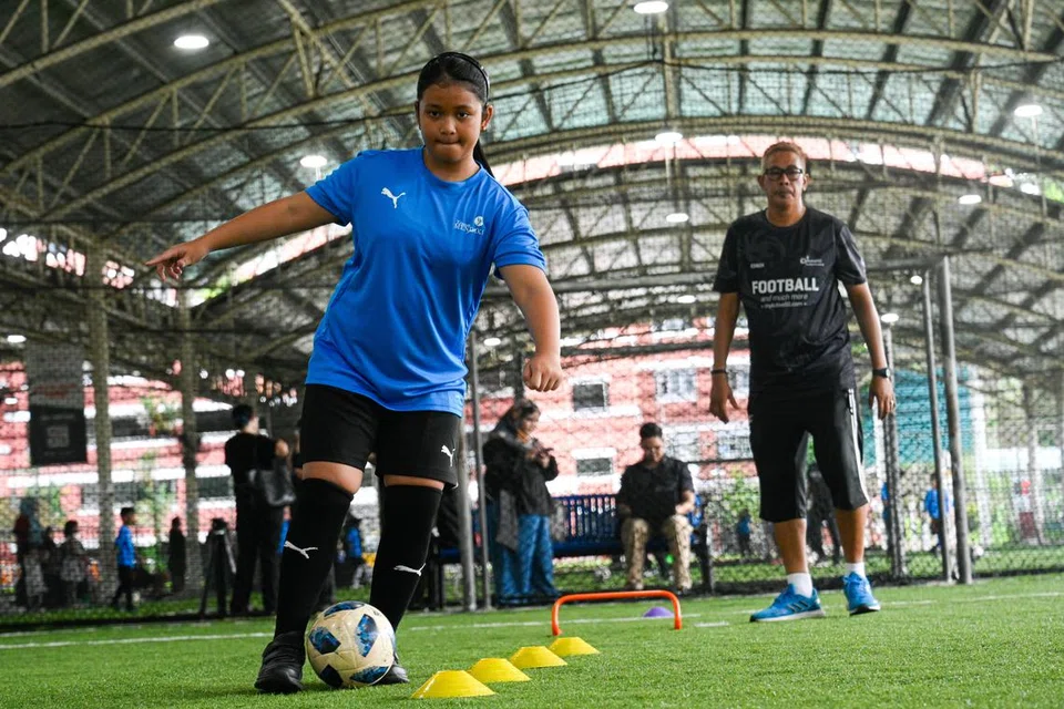 Noor Hozireen Muhammad Hozir, dilihat menggelecek bola di sesi latihan Kem Bola Sepak Badan Bantu Diri