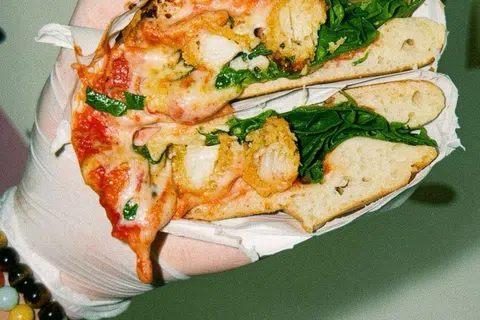 Panuozzo atau sandwic yang menampilkan Cheesy Chicken Parmesan, $13 yang mengandungi sos pomodoro, keju mozzarella, keju parmesan, ayam goreng dan arugula.