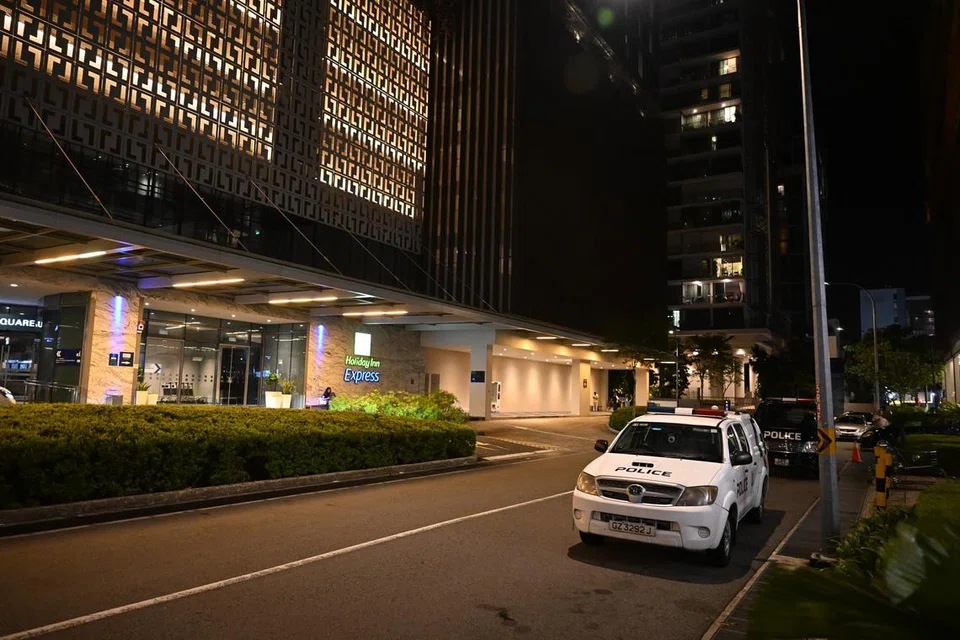 TEMPAT KEJADIAN: Kenderaan polis di tempat kejadian pembunuhan di hotel Holiday Inn Express, Katong, pada 10:30 malam pada 9 September. 