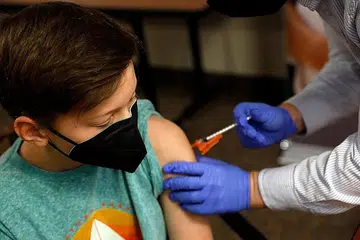 MANFAAT ATASI RISIKO: Kanak-kanak Aiden Arthurs menerima vaksin Covid-19 Pfizer-BioNTech Mei lalu di Bloomfield Hills, Michigan. Panel perubatan pemerintah Amerika menyimpulkan manfaat yang diketahui mengatasi risiko yang diketahui jika kanak-kanak mengambil vaksin itu. - Foto fail AFP