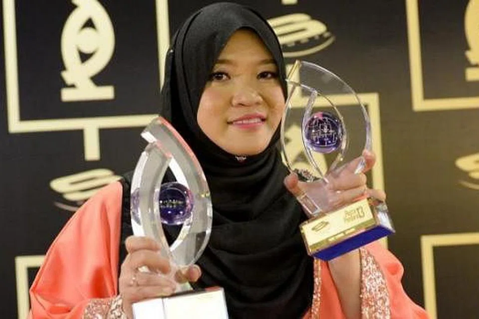 KEMENANGAN BERSAMA: Penyelia skrip dari MediaCorp Eaglevision, Wan Firzaleenazrah, berkongsi kemenangannya bersama "guru-gurunya" di Eaglevision. - Foto TUKIMAN WARJI
